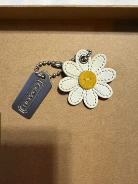 COACH White Daisy Leather Key Charm with Yellow Center